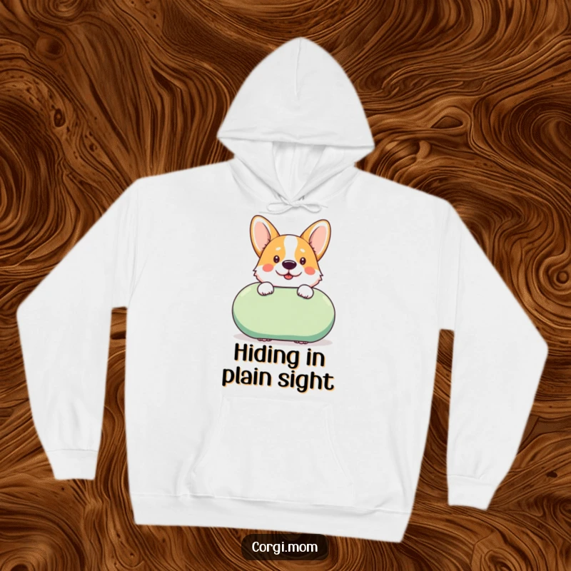Funny kawaii Corgi peeks cheekily from behind a giant squeaky toy on this comfortable and humorous hoodie.