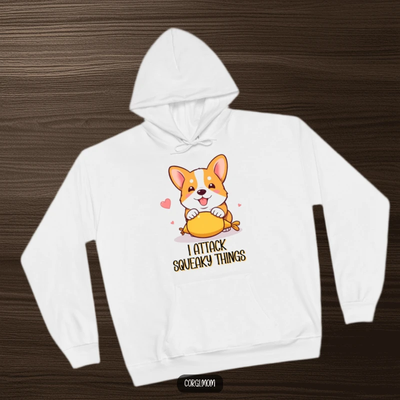 Funny kawaii corgi in a hilarious pouncing action on a squeaky toy, printed on a warm and comfortable hoodie.